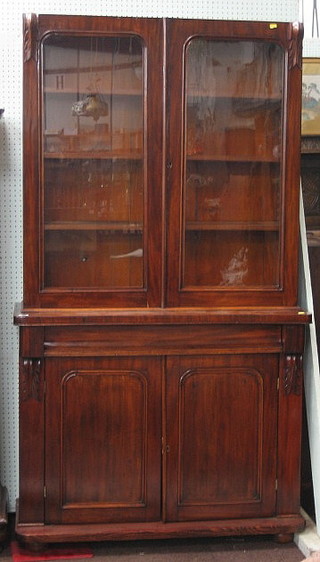 A Victorian mahogany bookcase on cabinet, the upper section fitted adjustable shelves enclosed by D shaped panelled doors, the base fitted a drawer above a double cupboard, raised on a platform base 29"