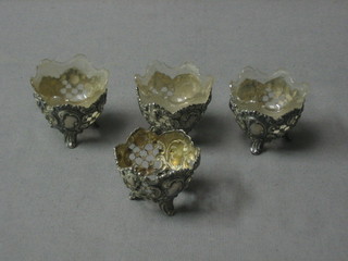 4 Continental pierced silver salts raised on panel supports, 3 with clear glass liners, marked 800