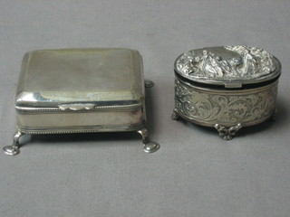 A square silver plated trinket box with hinged lid raised on 4 trifid feet 3" and an oval embossed silver plated trinket box 2 1/2"