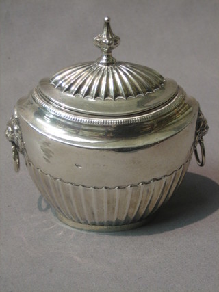 A silver oval reeded caddy with hinged lid and lion mask handles (marks rubbed) 6 ozs