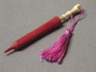 An ivory needle case in the form of a parasol 4"