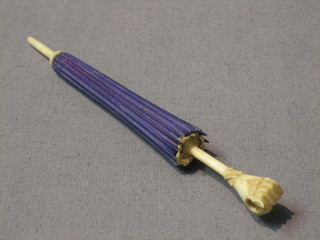 An ivory needle case in the form of a parasol the handle in the form of a grasped hand with Stanhope 4"