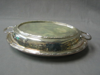 An oval silver plated entree dish and cover
