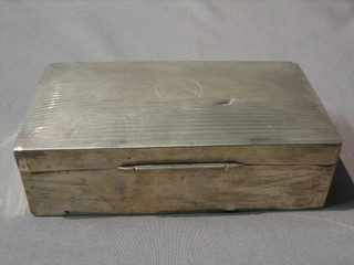 A silver cigarette box with engine turned decoration, Birmingham 1932, 6"