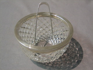 A circular cut glass bowl with silver rim 4 1/2" and a pair of silver sugar tongs with bright cut decoration
