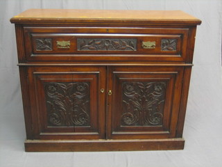 A Victorian carved walnut secretaire with fall front revealing a figured walnut interior fitted various drawers etc above a cupboard enclosed by carved panelled doors, raised on a platform base 48" (top badly polished) 