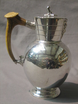 A silver plated hotwater jug with stag horn handle