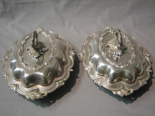 A pair of oval shaped silver plated entree dishes and covers by Elkington