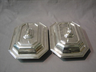 A pair of lozenge shaped silver plated entree dishes and covers