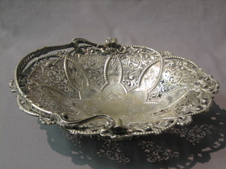 An oval pierced silver plated cake basket with swing handle, raised on an oval circular spreading foot