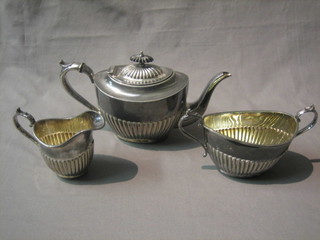 A Britannia metal 3 piece tea service of oval reeded form with teapot, twin handled sugar bowl and cream jug