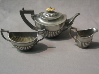 A Britannia metal 3 piece Bachelors tea service of oval form with demi-reeded decoration comprising teapot, twin handled sugar bowl and cream jug