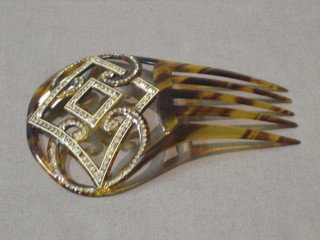 A tortoiseshell hair comb with diamonte decoration