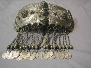 An Eastern embossed white metal "belt" hung chains and numerous coins
