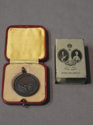 A metal match slip to commemorate the 1935 Jubilee of King George V and a bronze Royal Life Saving Association medal