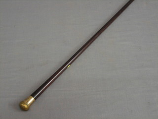 A walking stick with gilt metal handle