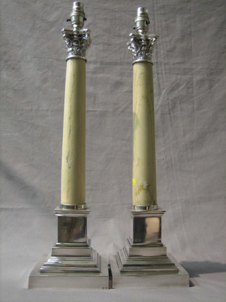 A pair of silver plated and white marble table lamps with Corinthian column capitals