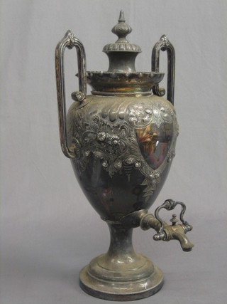 A Victorian twin handled embossed Britannia metal tea urn and cover 20"