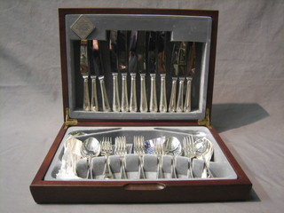 A modern canteen of silver plated cutlery with bead work border