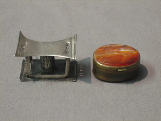 An oval hardstone pill box 1" and an Eastern silver model of a cheiftan's stool 2"