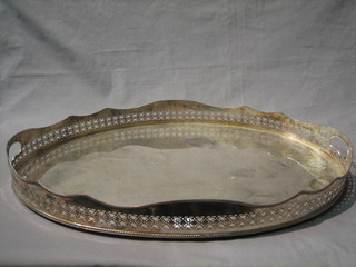 An oval pierced silver plated twin handled tea tray 24"