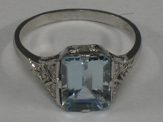 A lady's 18ct white gold dress ring set a rectangular cut aquamarine supported by 6 diamonds to the shoulders