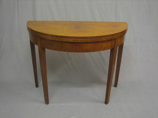 A 19th Century mahogany demi-lune card table, raised on square tapering supports 37"