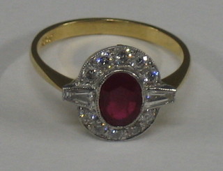 A lady's 18ct yellow gold dress ring set an oval cut ruby with baguette cut diamonds to the shoulders, supported by numerous diamonds (approx 0.50ct)