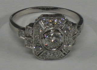 A lady's 18ct white gold dress ring set a central circular diamond supported by numerous diamonds (approx 0.66ct)