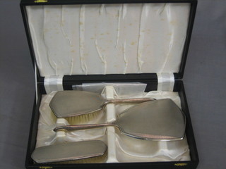 A 3 piece silver backed dressing table set with handmirror, hair brush and comb, Birmingham 1963