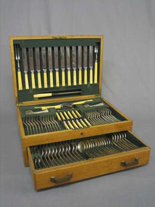A 107 piece canteen of silver plated Old English pattern flatware (monogrammed), contained in an oak canteen box