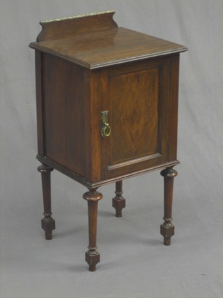 An Edwardian inlaid walnut pot cupboard enclosed by a panelled door raised on turned supports 16"