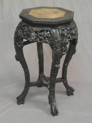 A 19th Century octagonal carved and pierced hardwood jardiniere stand with pink veined marble top, raised on cabriole supports (top f) 12"