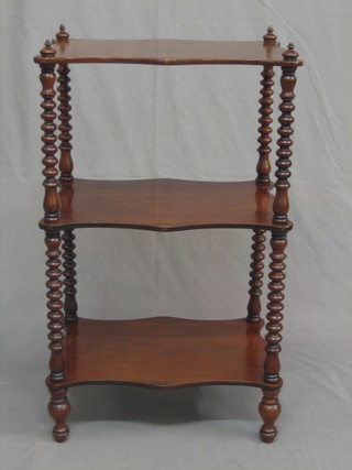 A Victorian mahogany 3 tier what-not stand of serpentine outline, raised on spiral turned columns 20"