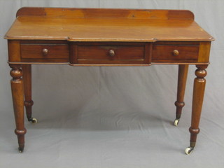 A Victorian shaped mahogany side table with 3 long drawers, raised on turned supports ending in brass caps and castors, 44"