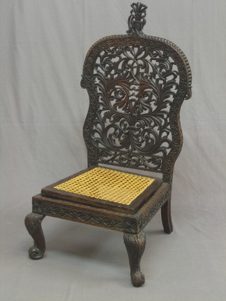 A 19th/20th Century Eastern pierced and carved hardwood high back chair with woven cane drop in seat, raised on cabriole supports