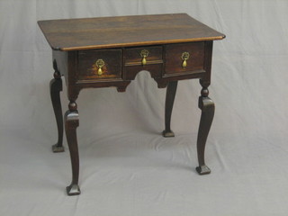 An 18th Century oak low boy, fitted 1 short and 2 long drawers, raised on cabriole supports 13"