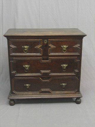 A 17th/18th Century oak chest of 3 long drawers with replacement brass handles, raised on bun feet (bun feet wormed) 36"