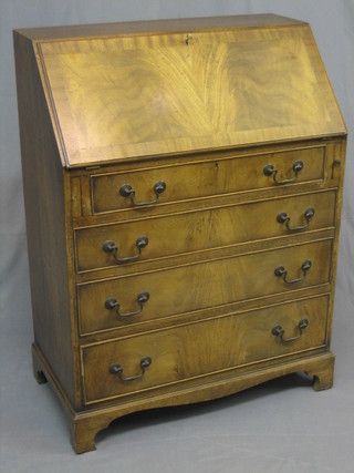 A Georgian style walnut bureau with fall front revealing a fitted interior above 3 long graduated drawers raised on bracket feet 29"