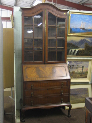 A Queen Anne style bureau bookcase, the interior fitted shelves enclosed by astragal glazed panelled doors, the base with fall front revealing a well fitted interior above 3 long drawers, raised on cabriole supports 35"