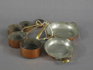 A circular reproduction twin handled saucepan 7", 1 other 6" and 5 graduated saucepans