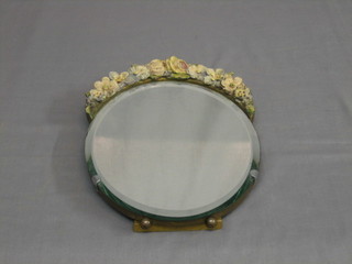 An oval bevelled plate easel mirror with barbola mounts 12"