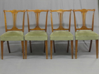 A set of 4 Edwardian Georgian style mahogany splat back dining chairs with upholstered seats raised on square tapering supports