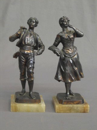 A pair of 19th/20th Century Continental spelter figures of walking gentleman and standing lady, raised on marble bases 10"