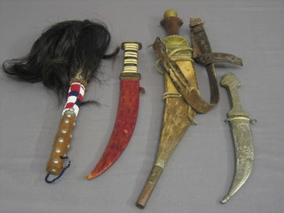 An Eastern dagger, 2 Eastern tourist daggers and a fly swish