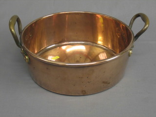 A copper twin handled preserving pan with brass handles