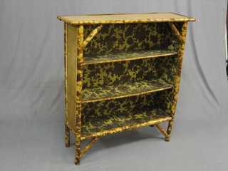 A 19th/20th Century bamboo bookcase with inset tooled leather top 36"