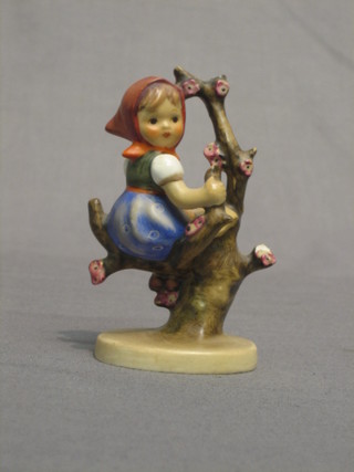 A Goebal figure of a girl sat on a branch 4" high