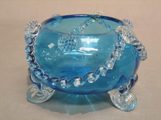 A 19th/20th Century circular blue glass bowl with clear glass swag decoration, on 3 clear glass scrolled supports 5"