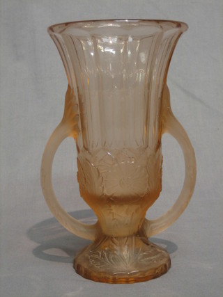 A pink tinted twin handled glass vase raised on a circular spreading foot 10"